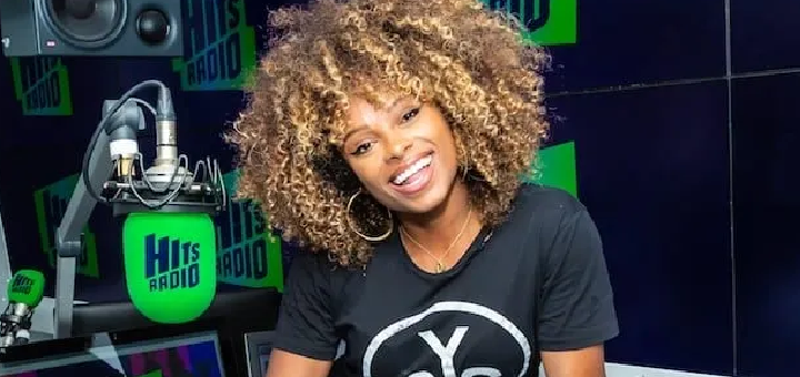 Fleur East from Hits Radio smiling in the studio