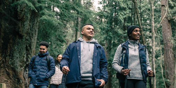 Group of friends walking through a forest