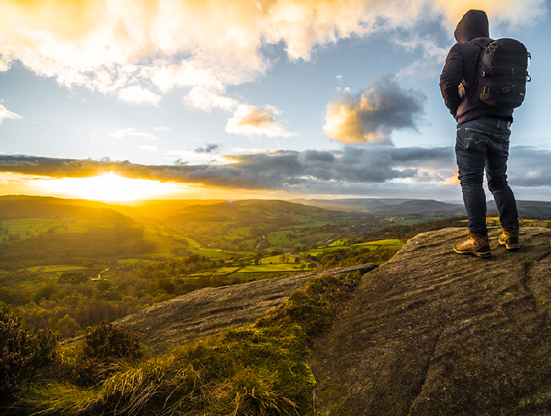 Image of man overlooking a British countryside at sunset
